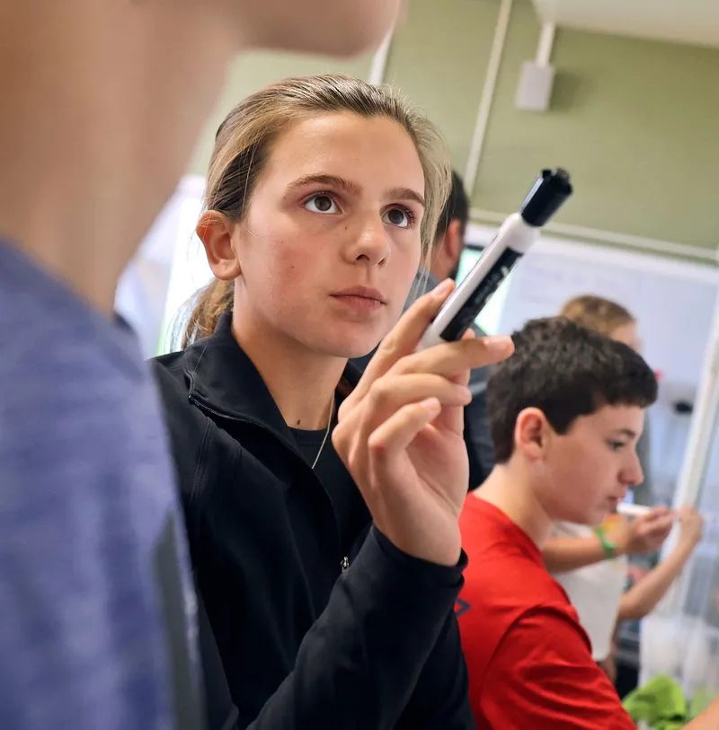 A student concentrating in a classroom